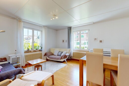 living / dining area with wood finished floors, radiator heating unit, and radiator