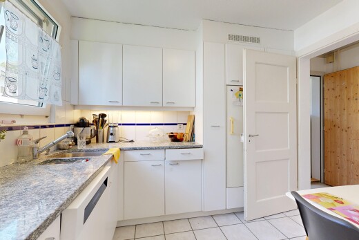 kitchen featuring white cabinetry, white dishwasher, light tile patterned floors, and light stone counters