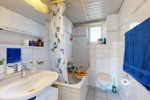full bath with tile walls, tiled shower / bath combo, and light tile patterned flooring