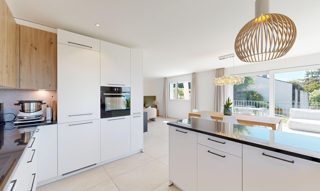 cuisine avec white cabinets, armoires blanches, dark countertops, light floor, et flat panel cabinets