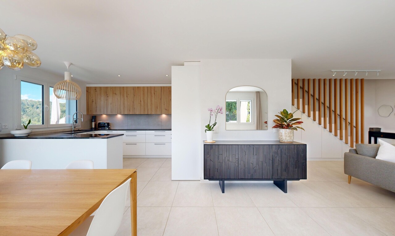 cuisine avec escaliers, flat panel cabinets, armoires à panneau plat, light floor, et dark countertops