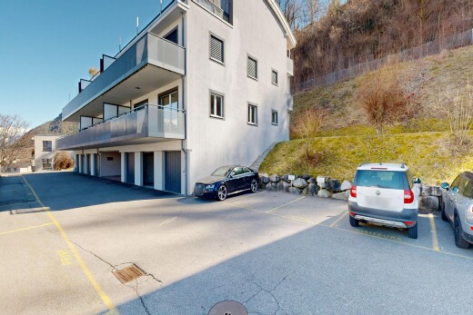 view of apartment building / complex with uncovered parking