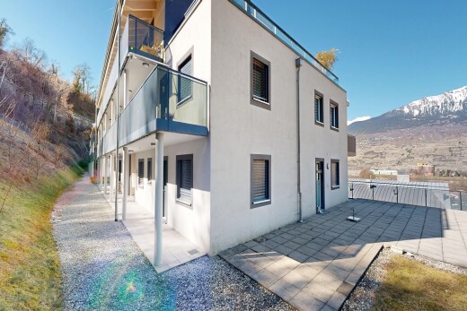 view of home with stucco siding, a balcony, a mountain view, and a patio