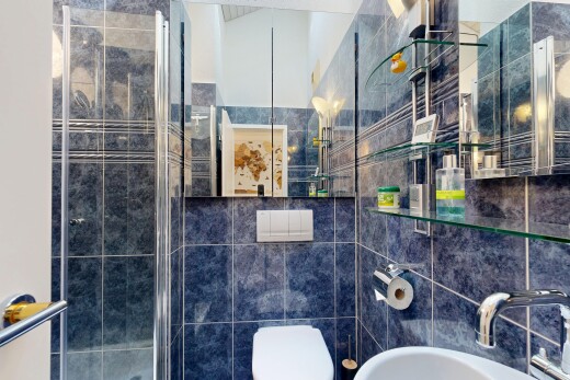 bathroom featuring a shower stall and tile walls