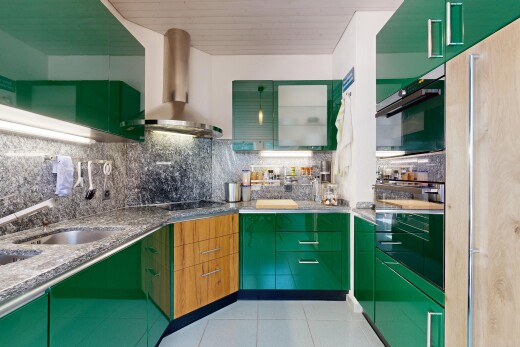 kitchen featuring green cabinets, tasteful backsplash, stone counters, and light tile patterned flooring