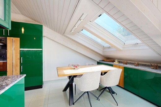 dining space featuring vaulted ceiling with skylight, light tile patterned flooring, and wood ceiling