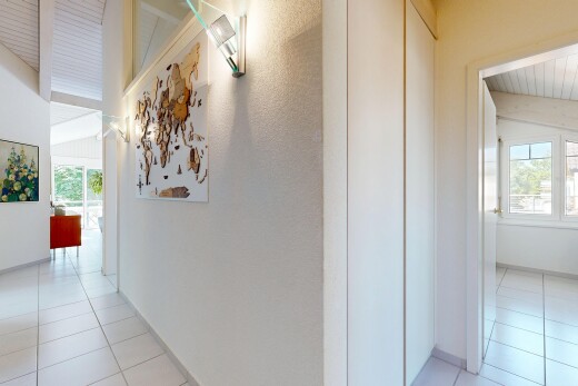 corridor with wood ceiling, light tile patterned floors, and vaulted ceiling with beams