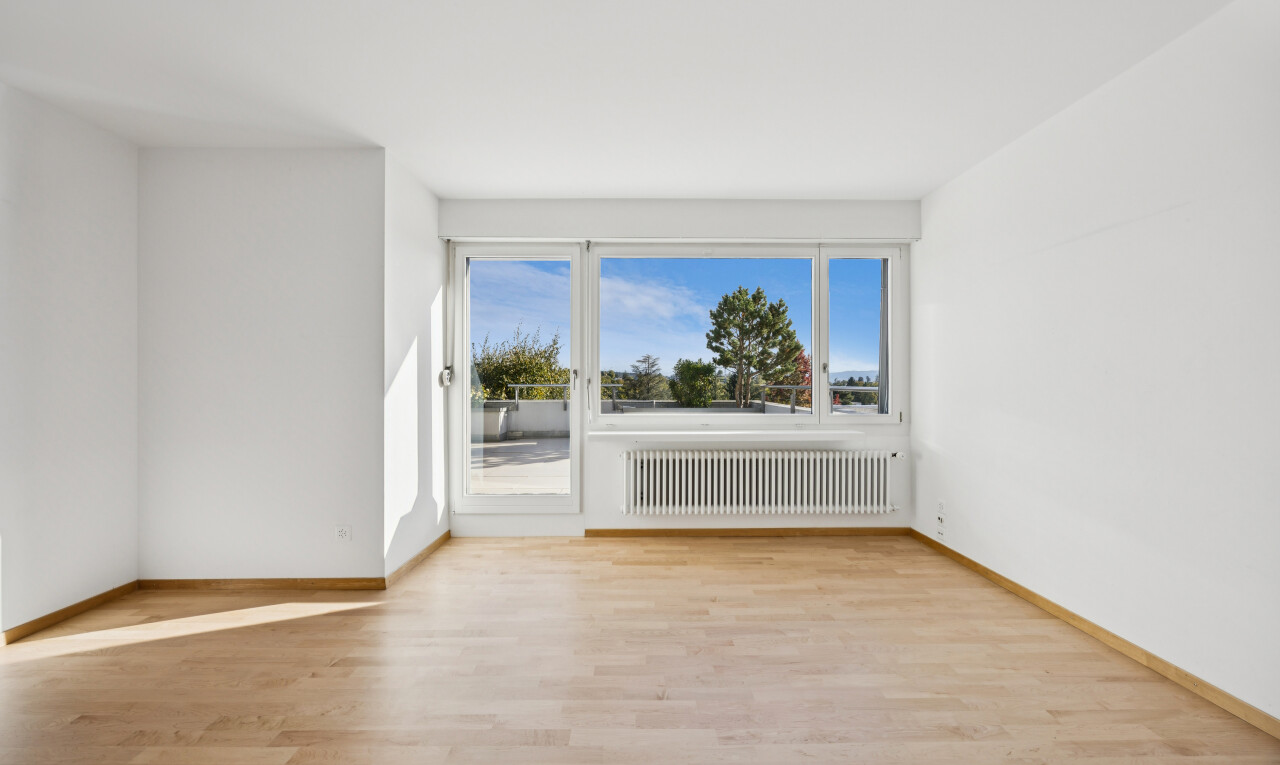 empty room featuring radiator and light wood finished floors