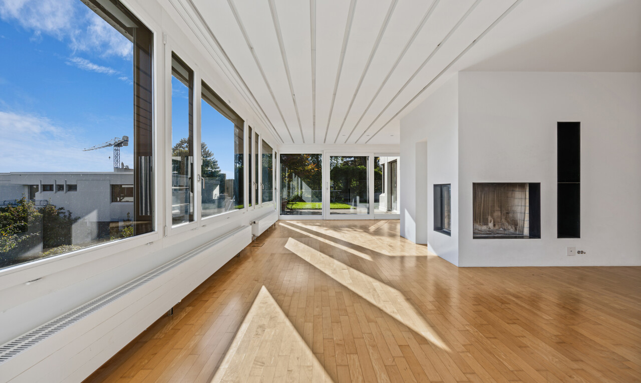 spare room with a baseboard radiator, a fireplace, and light wood-style floors