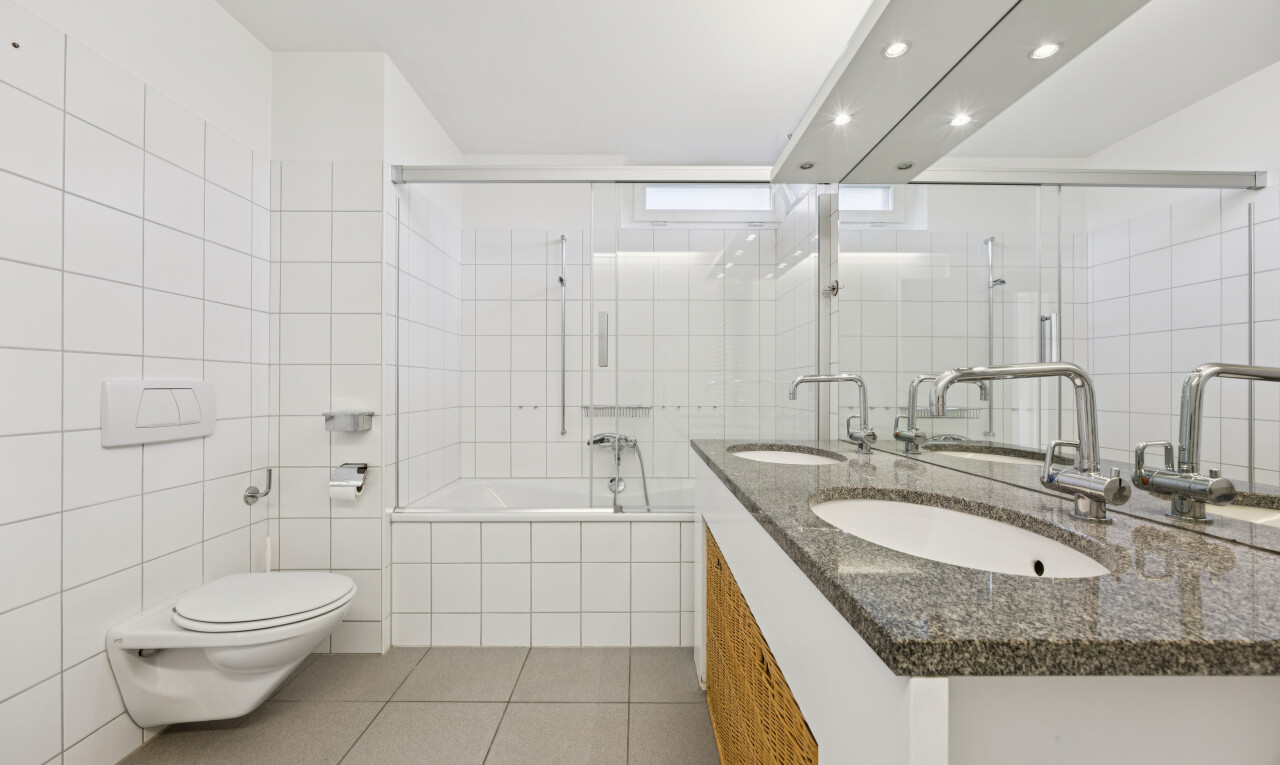 bathroom featuring tile walls, light tile patterned floors, double vanity, tiled shower / bath, and recessed lighting
