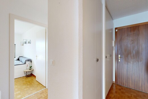 corridor featuring parquet floors and a textured ceiling