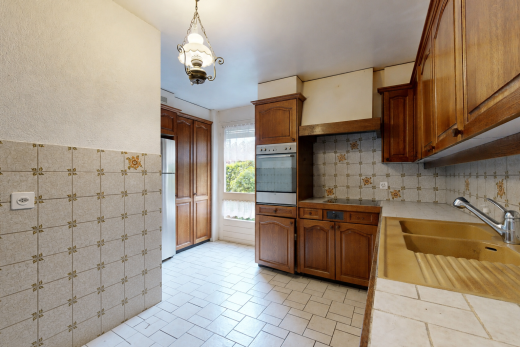 küche mit bogenförmige schränke, arched cabinets, light countertops, ofen, und mittelbraune schränke