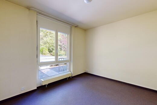 unfurnished room with dark carpet and a baseboard heating unit