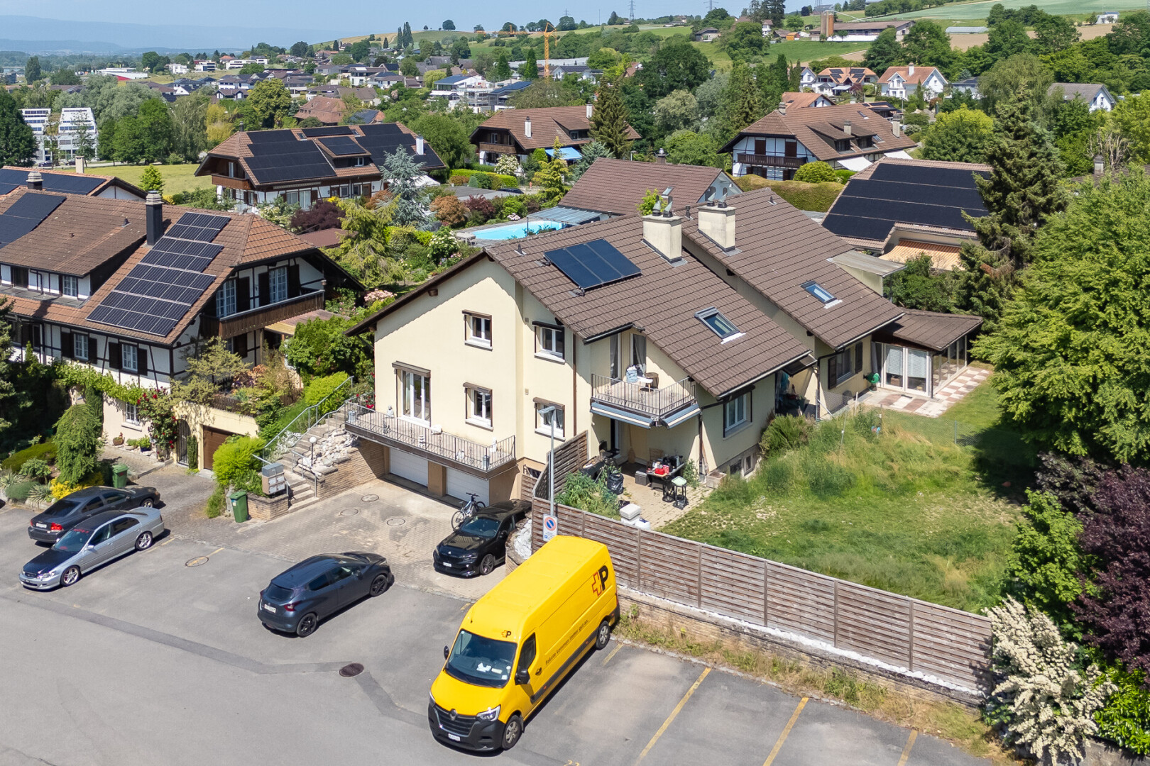 view of property with an attached garage and solar panels