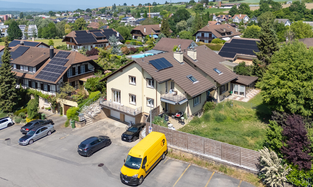 view of property with an attached garage and solar panels