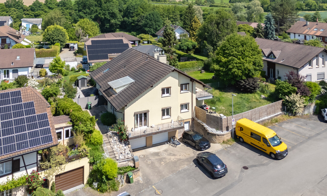 view of property featuring stucco siding, a residential view, and a garage