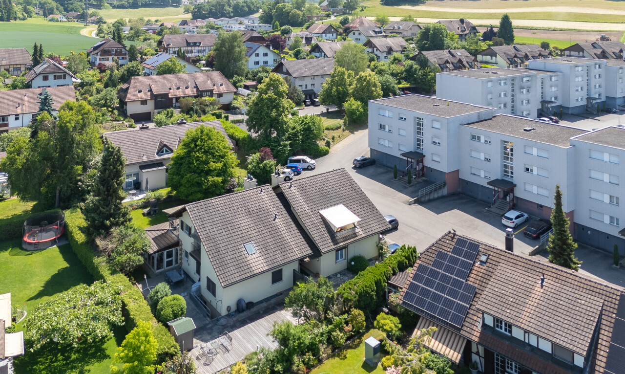 view of home featuring solar panels, view of golf course, and stucco siding