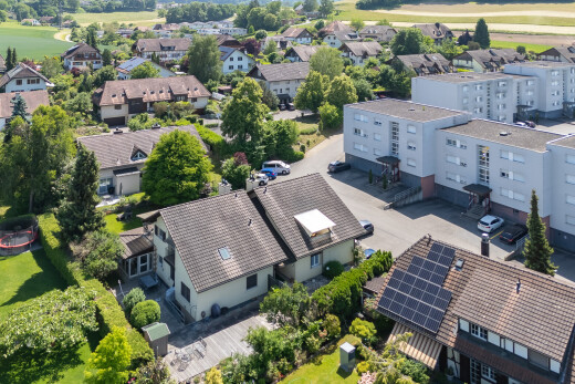 view of home featuring solar panels, view of golf course, and stucco siding