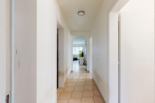 hallway featuring arched walkways
