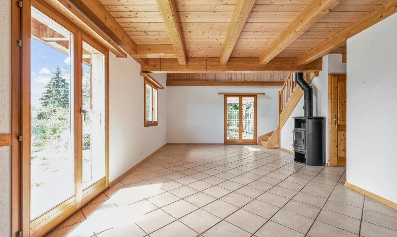 pièce vide avec beamed ceiling, plafond à poutres, poêle à bois, wood ceiling, et plafond en bois