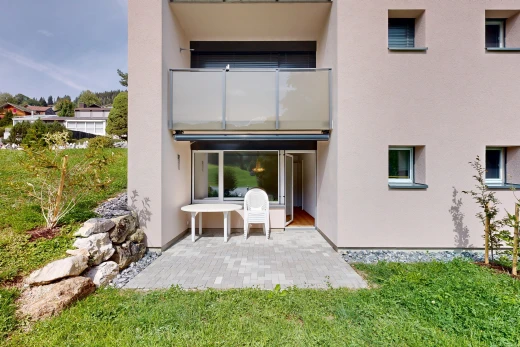 façade avec bardage en stuc et pelouse