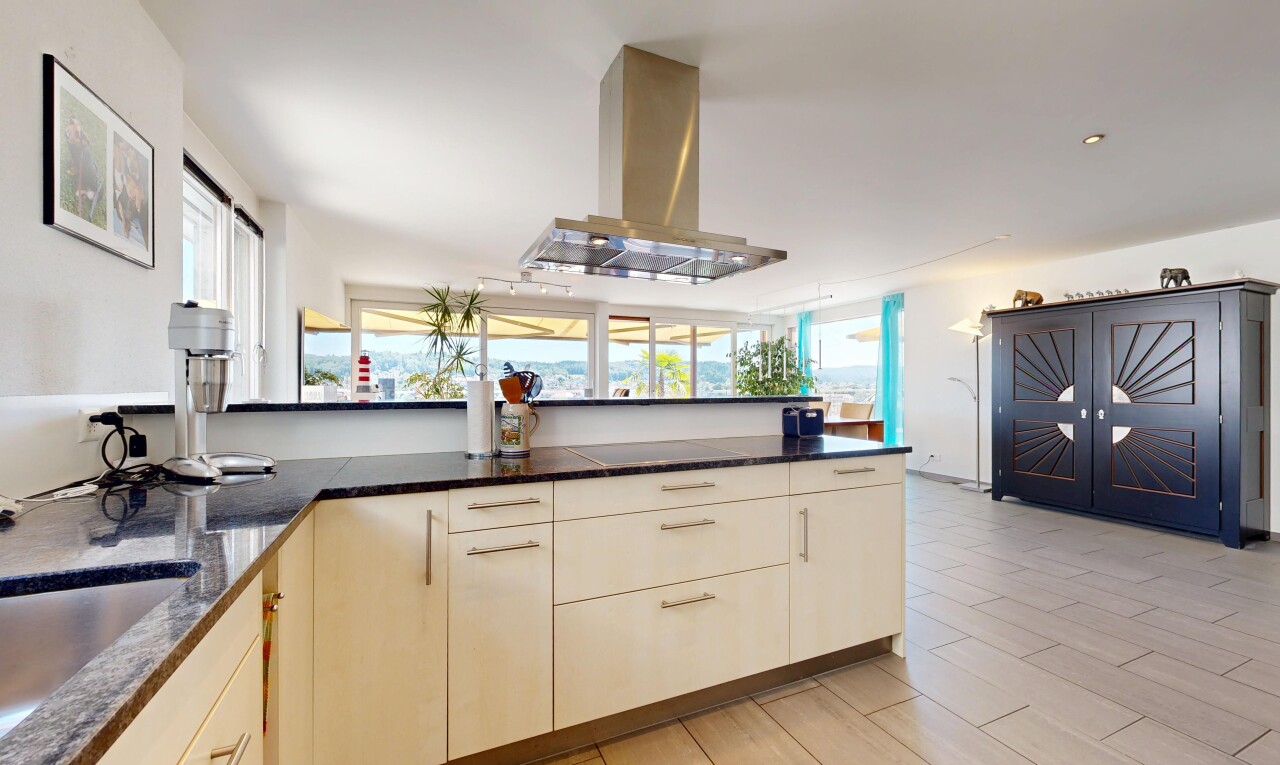 küche mit dark countertops, dunstabzugshaube, light floor, two heights countertops, und holzfußboden