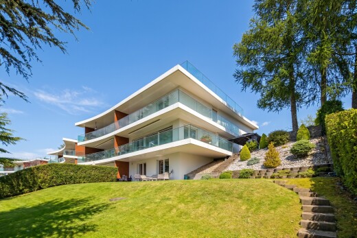 outdoor house featuring a yard and a balcony