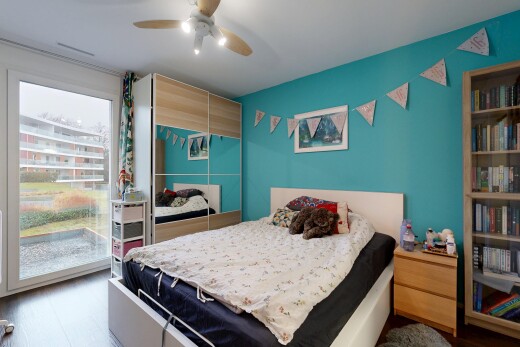 room / bedroom with access to exterior, wood finished floors, and ceiling fan