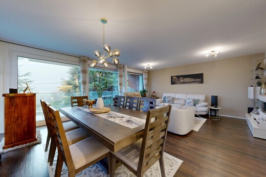 living / dining room featuring dark wood-style floors and a chandelier