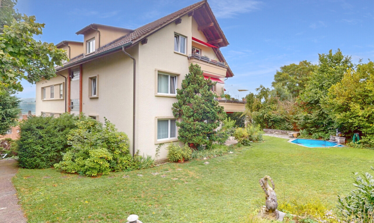 façade avec pelouse, property visible, bardage en stuc, et day time