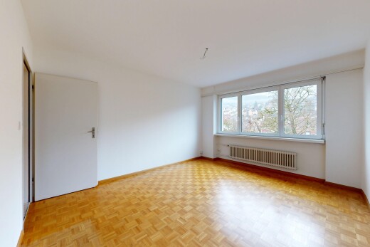 pièce vide avec parquet floor, cloison sèche, drywall, radiateur, et lumière naturelle