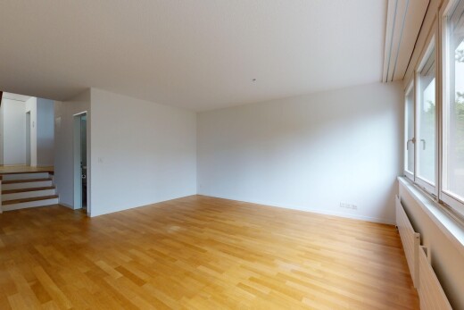 spare room with light wood-type flooring, stairway, and radiator heating unit