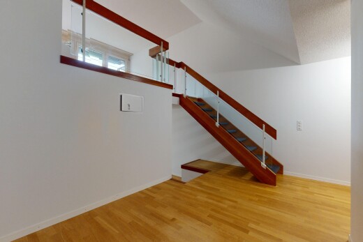staircase featuring wood finished floors and a textured ceiling