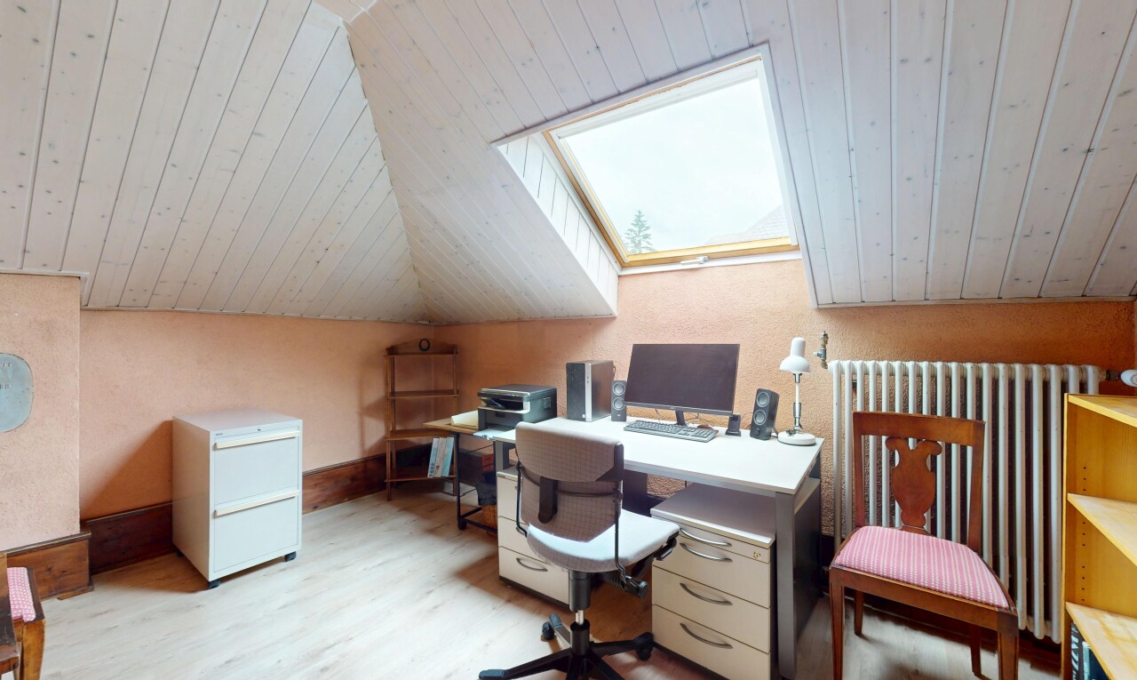 bureau avec pièce supplémentaire, télévision, sol en finition bois, wood finish floor, et puits de lumière