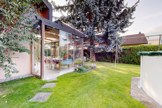 garden featuring a sunroom and a patio