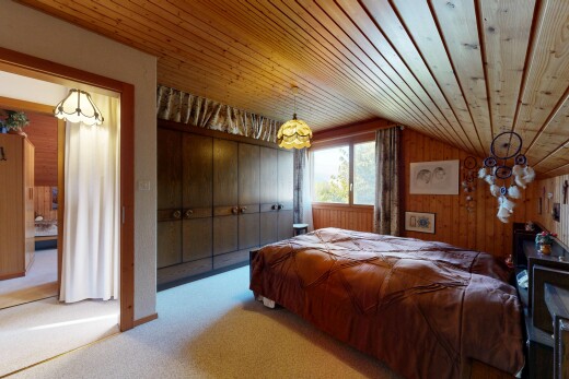 carpeted room featuring wooden walls, vaulted ceiling, wood ceiling, and a chandelier