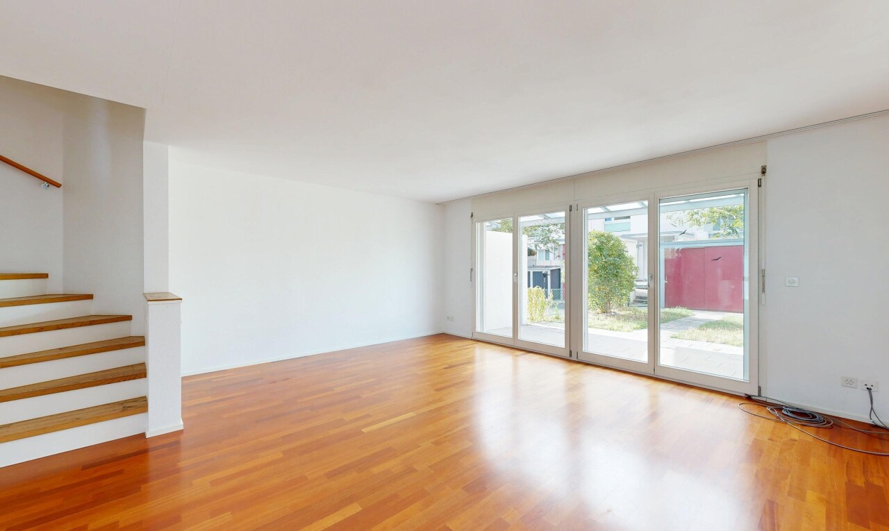 unfurnished room featuring stairway and light wood finished floors