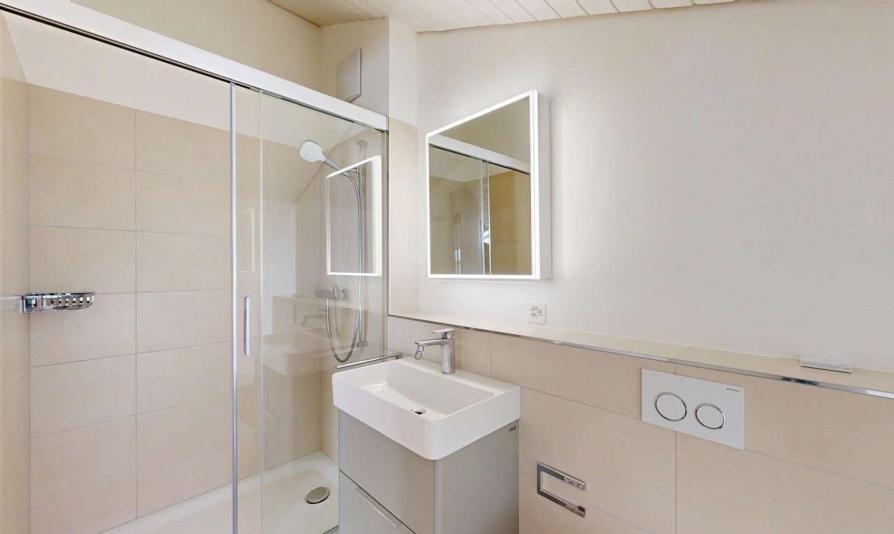 full bath with a shower stall and vanity