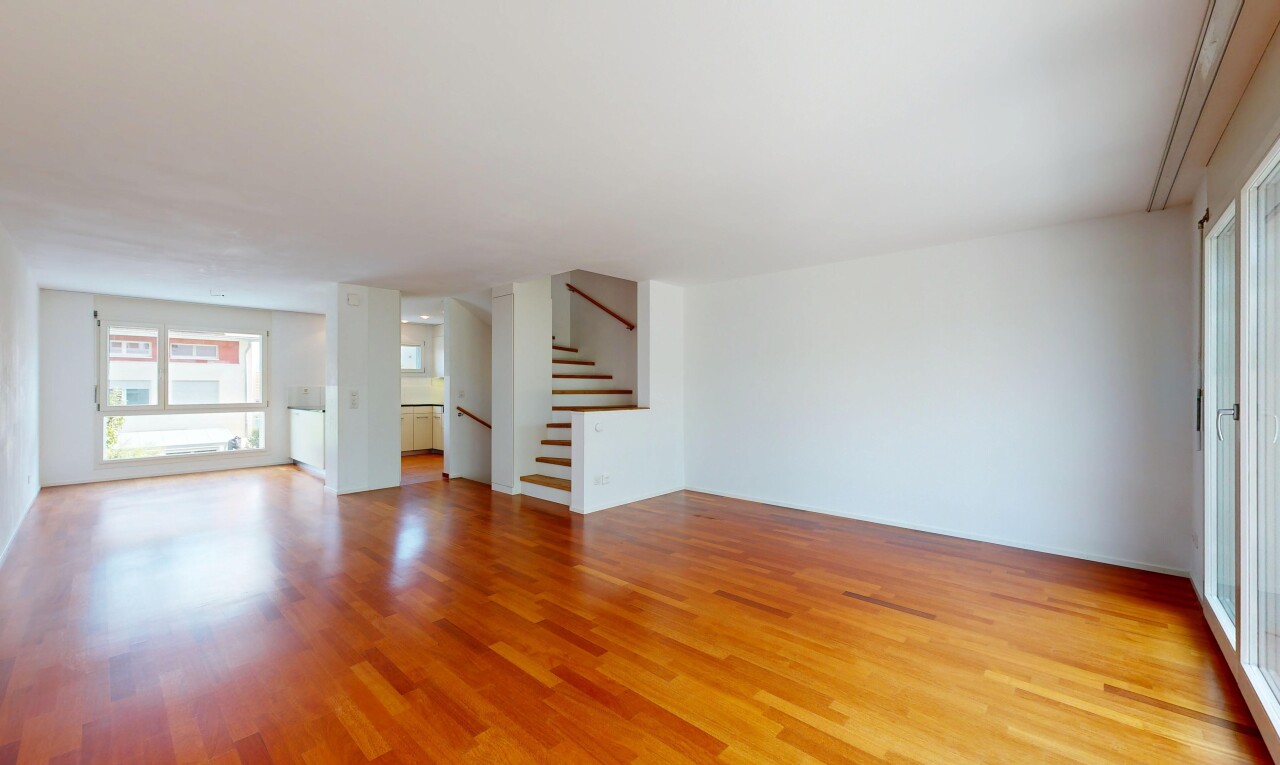 unfurnished room featuring stairway and wood finished floors