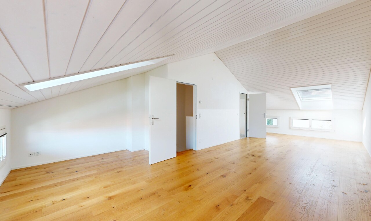 empty room featuring light wood-style flooring and a vaulted wooden ceiling