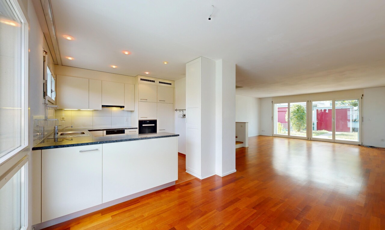 kitchen with open floor plan, dark countertops, a peninsula, light wood-style floors, and white cabinets