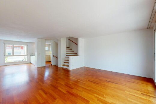 unfurnished room featuring stairway and wood finished floors