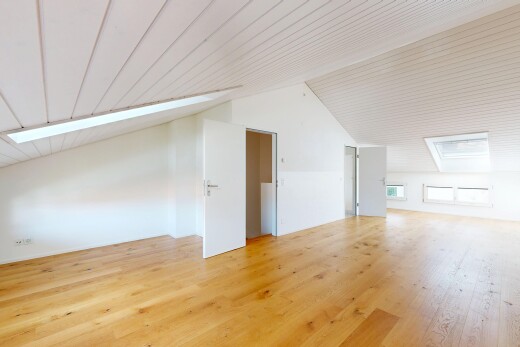 empty room featuring light wood-style flooring and a vaulted wooden ceiling