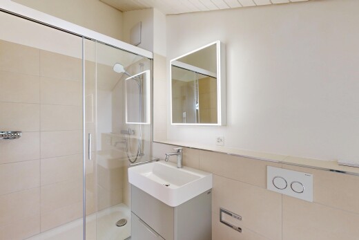 full bath with a shower stall and vanity