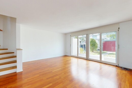 unfurnished room featuring stairway and light wood finished floors