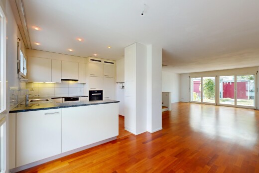 kitchen with open floor plan, dark countertops, a peninsula, light wood-style floors, and white cabinets