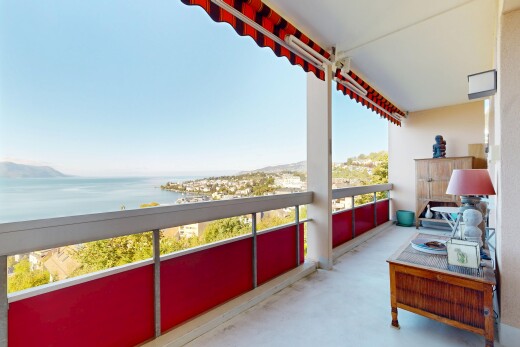 patio / terrace with a balcony and a water view