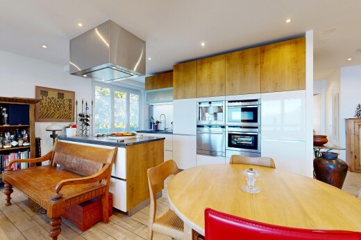two tone kitchen with recessed lighting, two tone color scheme, light wood-style flooring, and double oven