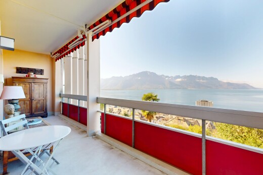 balcony featuring a water and mountain view