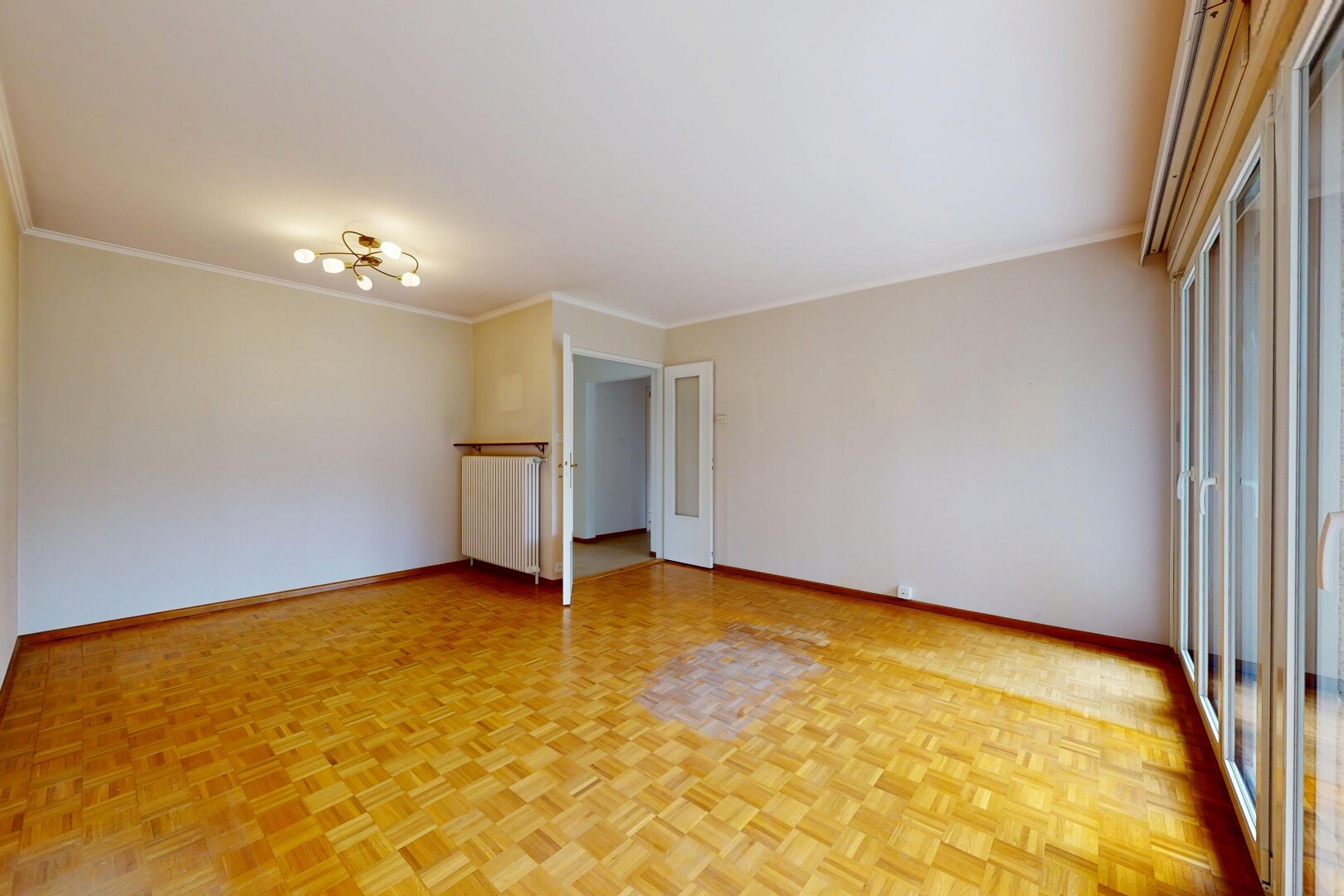 unfurnished room featuring parquet floors, radiator, and ornamental molding